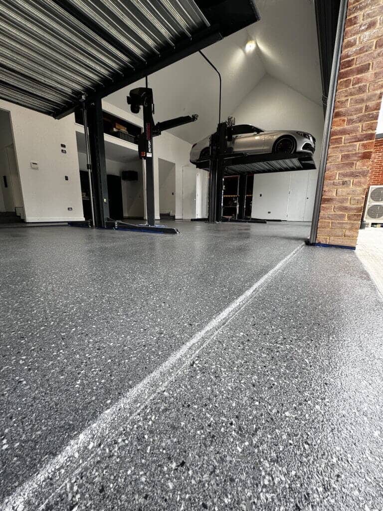 Luxury Garage with Car Lift by GR8 Paints & Epoxies